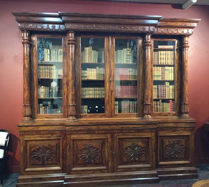 Large carved antique breakfront bookcase with glazed doors